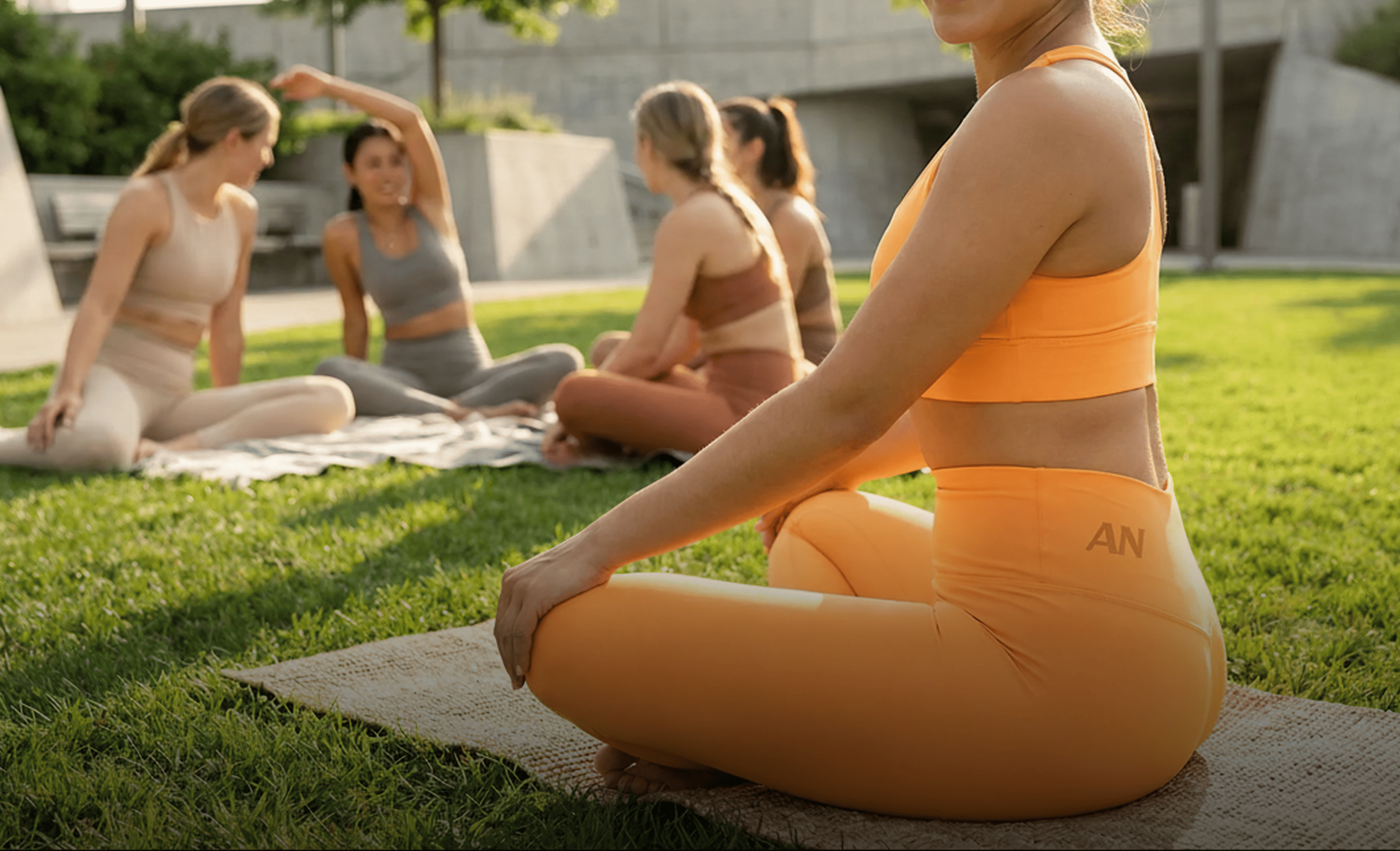 a man is sitting in his minimalistic modern office, laptop on the table, and holding a baseball cap in his hands, happily looking at it