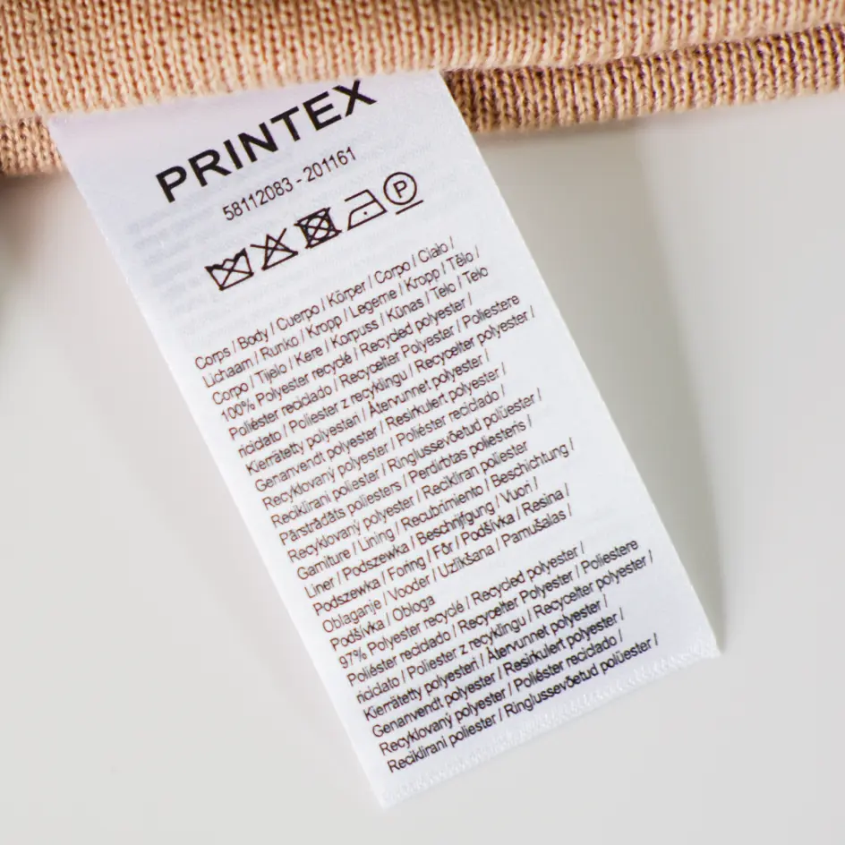Custom care labels illustrating important care instructions for garments, ensuring optimal maintenance and durability of fabrics.