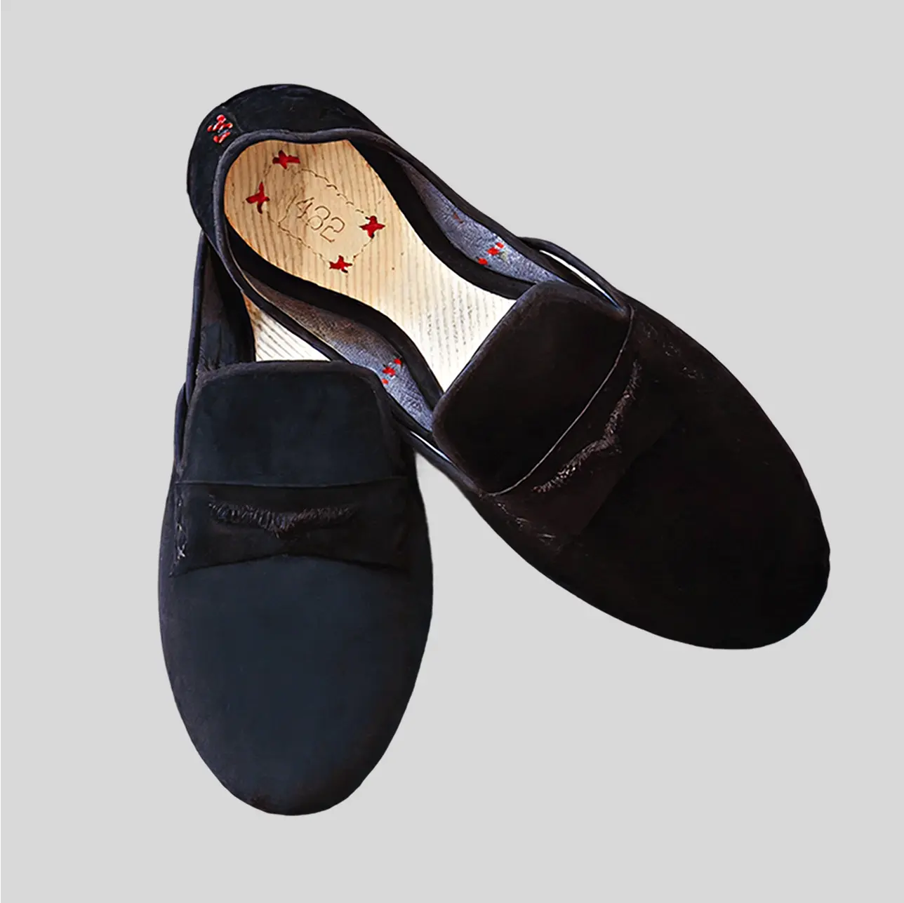 A pair of luxurious velvet slippers with a black finishing