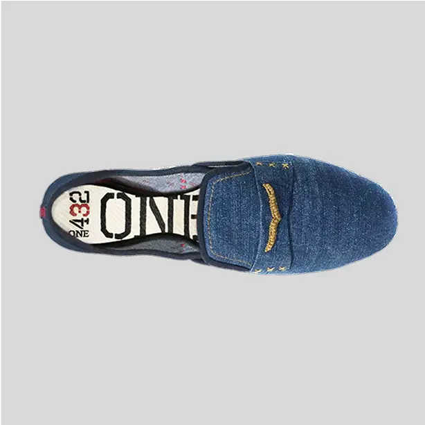 Top view of a classic pair of velvet slip-ons with a sleek, minimalist design.