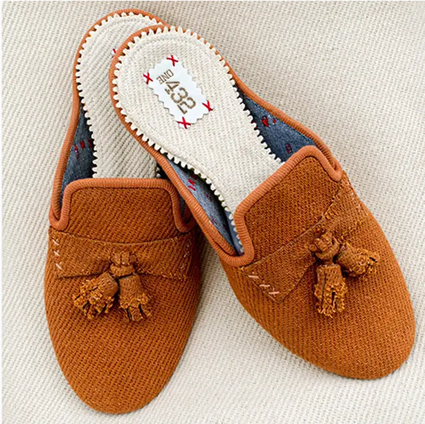 Golden brown cotton slide slippers with a minimalist design for a warm, earthy look.