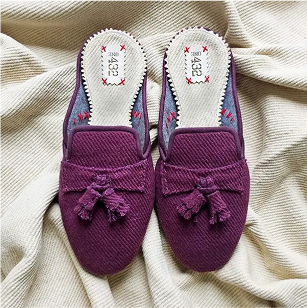 A cozy pair of mauve cotton slide slippers styled with neutral loungewear.