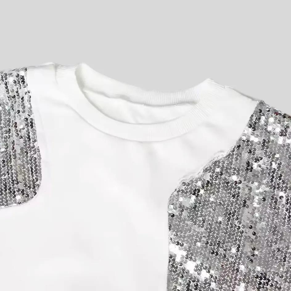 Dazzling sequins sewn onto a sweatshirt, creating a shimmering and eye-catching accent.