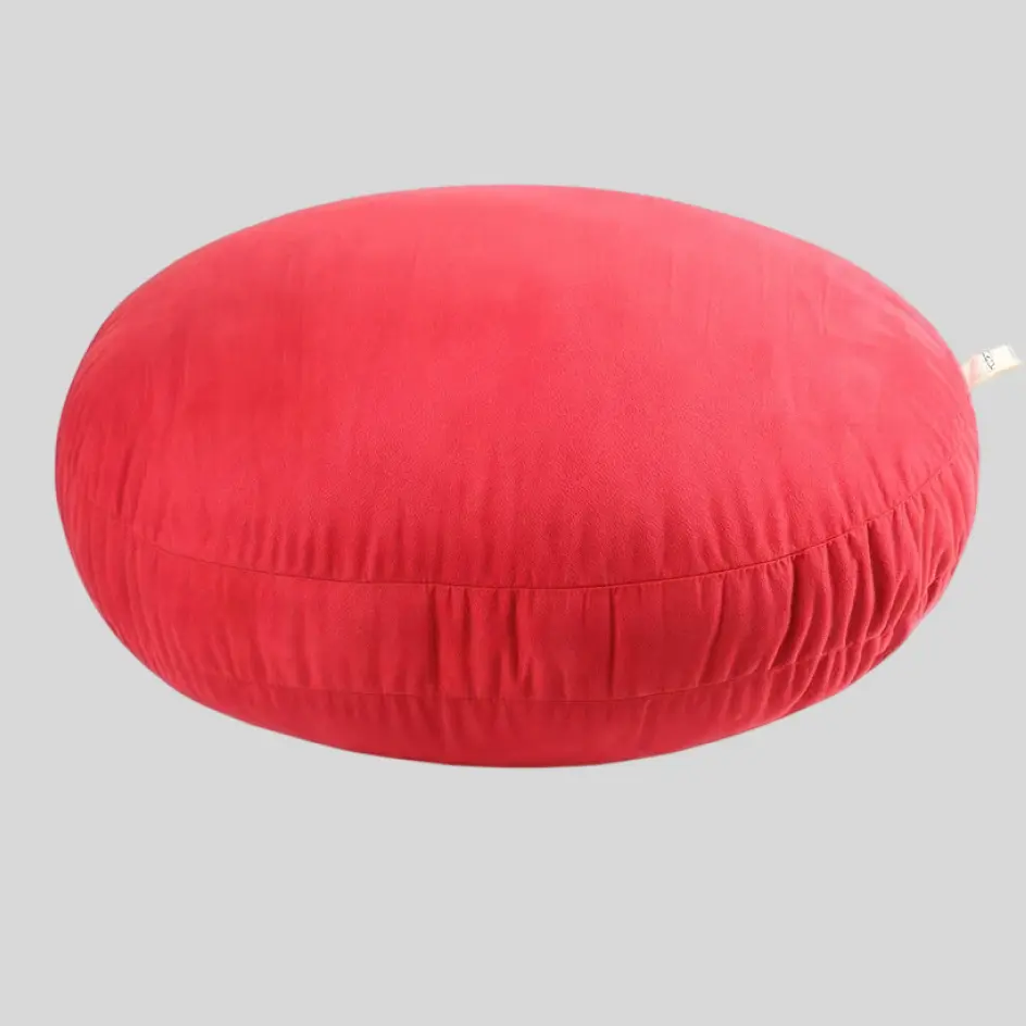 A cozy round pillow with a plush, soft texture, adding a stylish and inviting touch to any space.