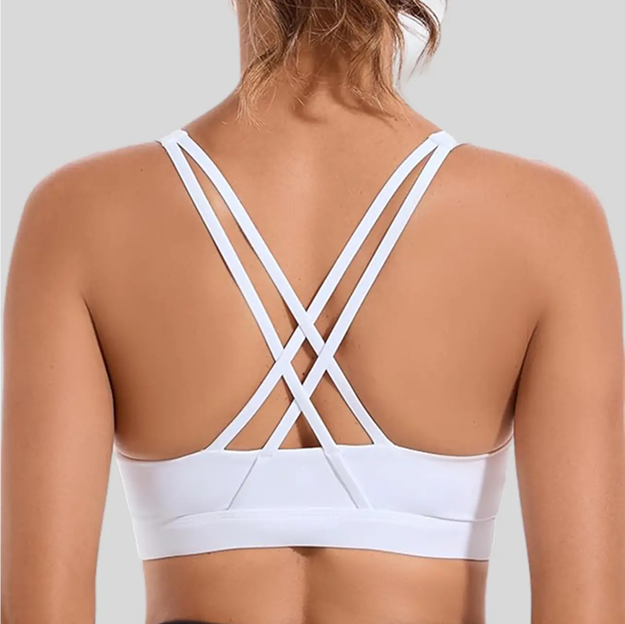 A stylish strappy sports bra with an intricate back design, combining function and fashion.