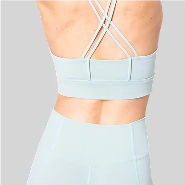 A breathable strappy yoga bra with removable padding, offering versatility and comfort.