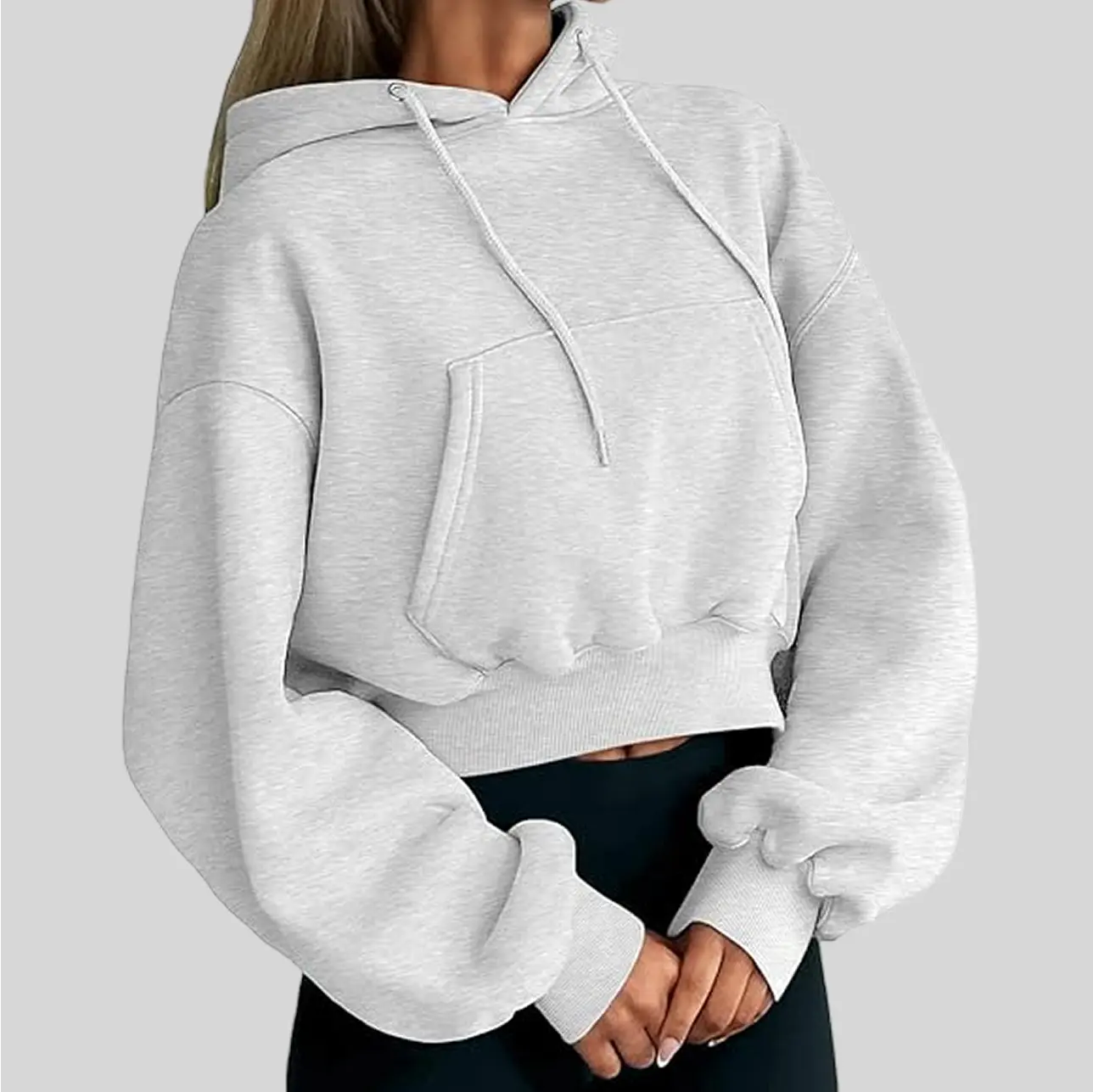 A trendy cropped yoga hoodie with a loose fit, offering a stylish and cozy look.