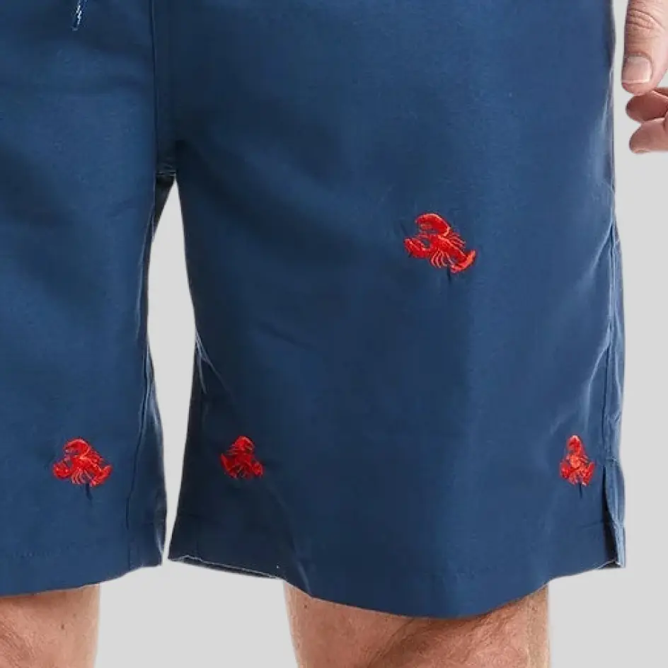 A pair of elastic-waist fishing shorts with embroidery, featuring a finely stitched logo for a premium and professional touch.