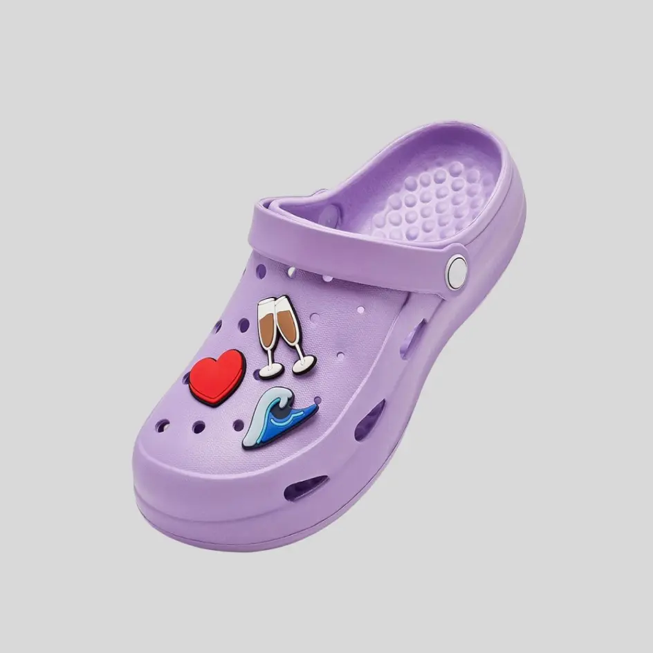 A pair of clogs decorated with jibbitz charms, allowing for fun and creative customization.