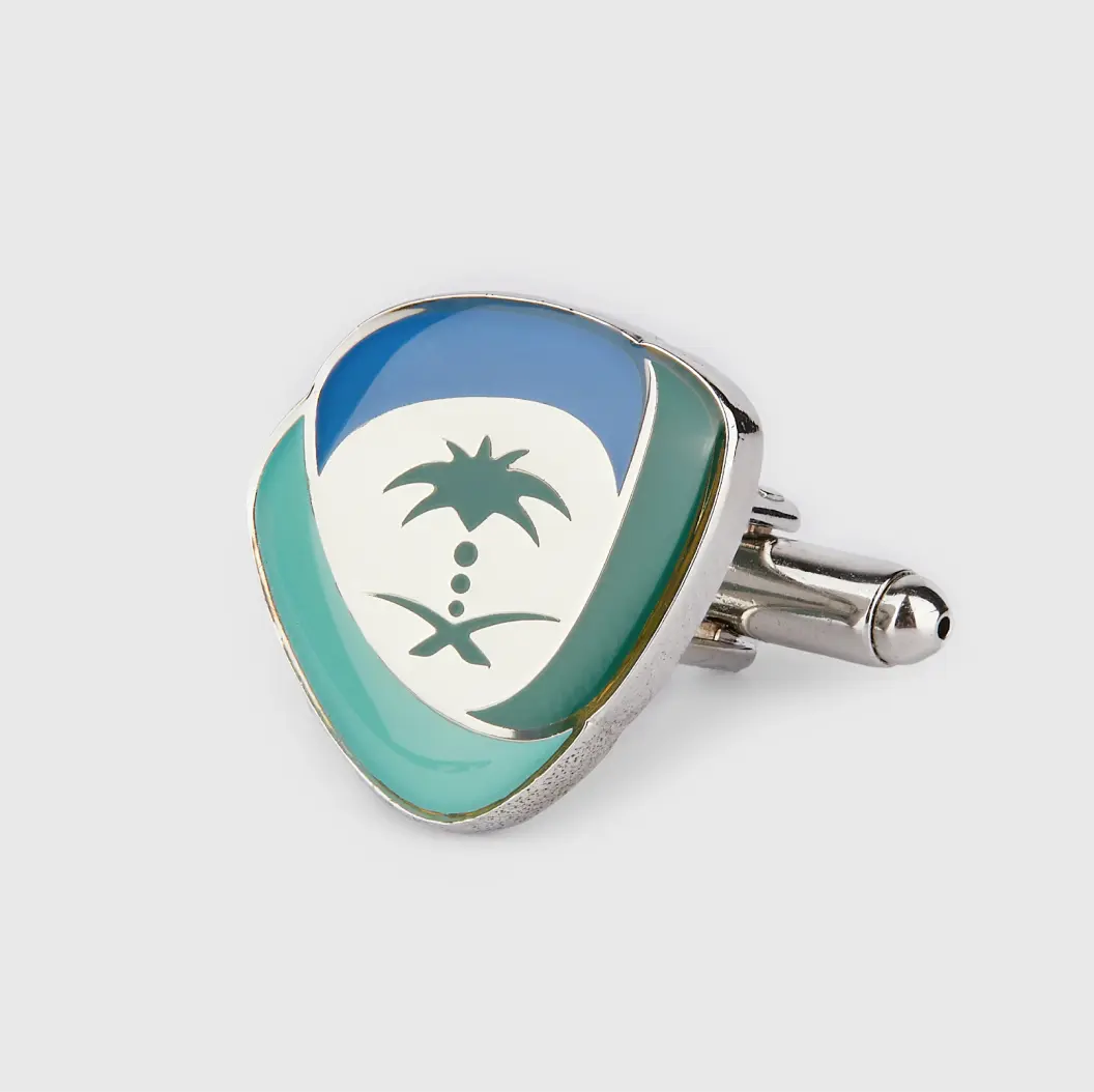 Enamel cufflink with a palm tree design in green, white, and blue