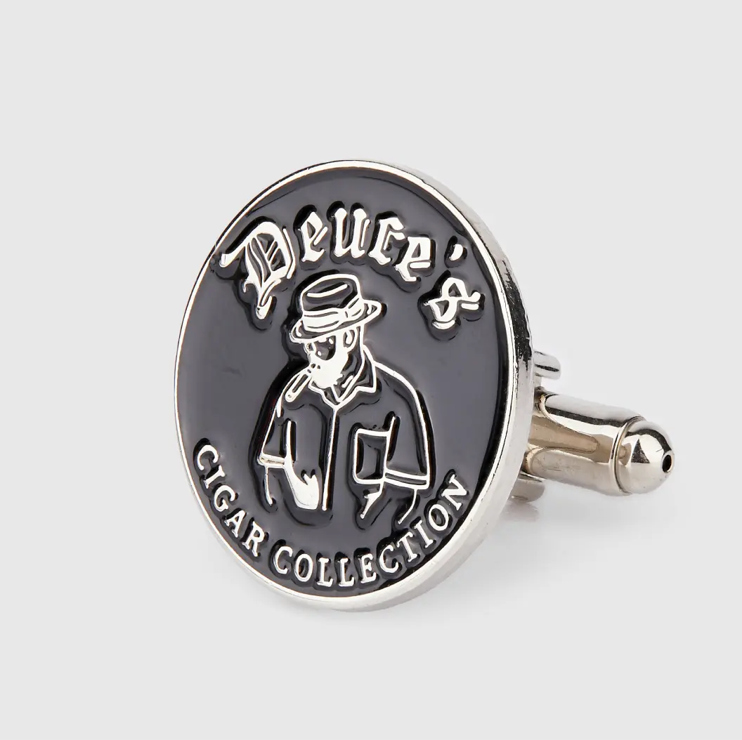 Black enamel cufflink with a cigar-themed logo and text “Deuce’s Cigar Collection”