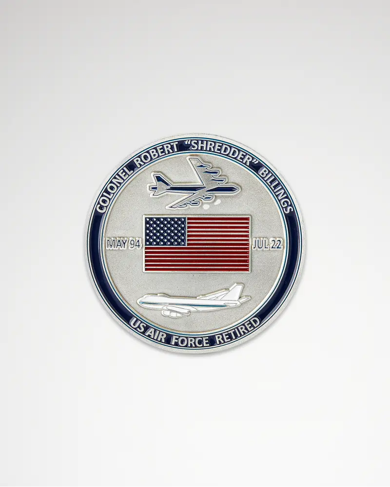 Round silver coin with an American flag and airplane design, labeled “Colonel Robert ‘Shredder’ Billings.”