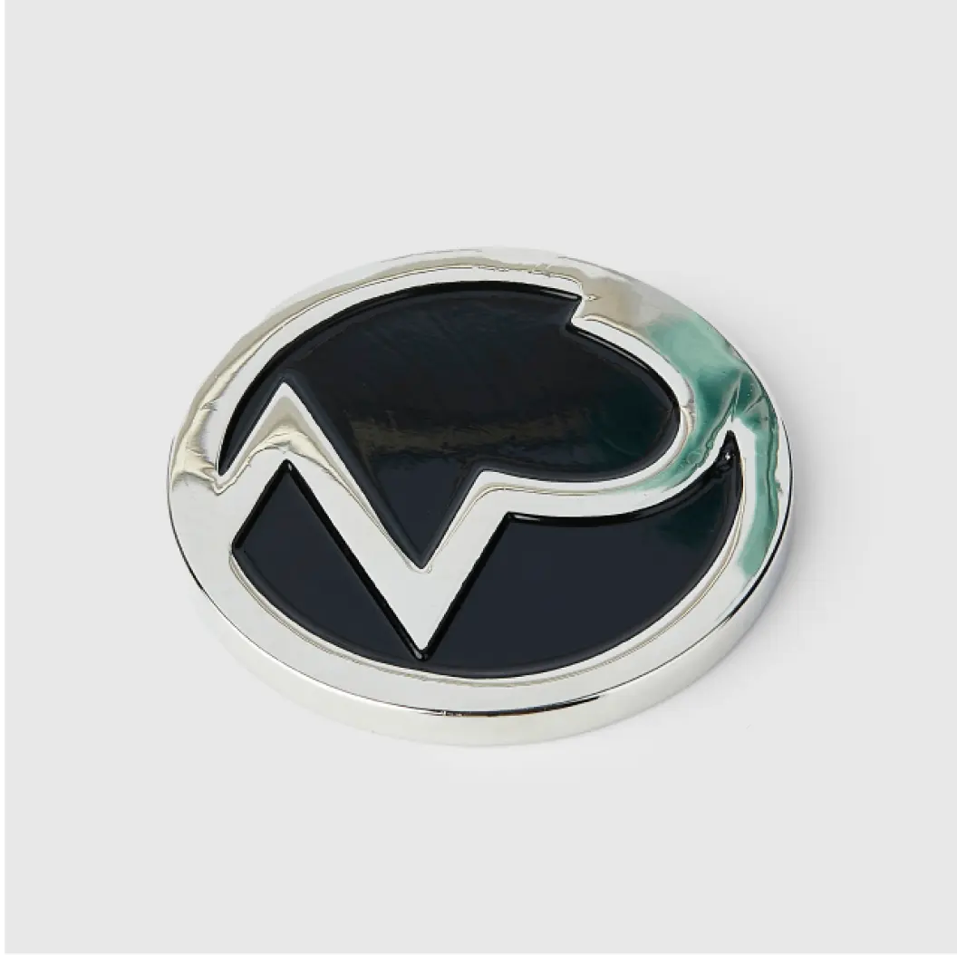 Silver coin with black logo and metallic finish.