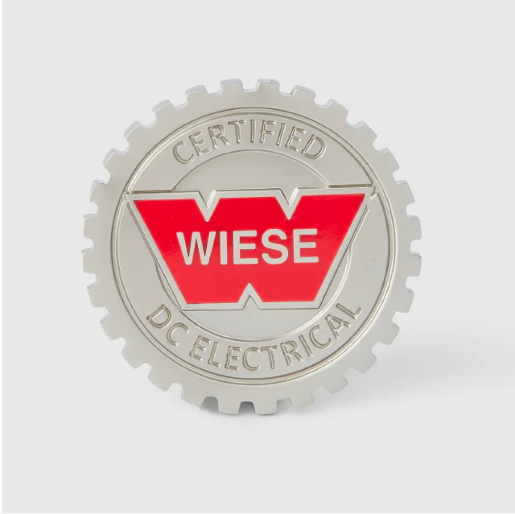 Silver coin with a red “Wiese” logo and cog-shaped border.