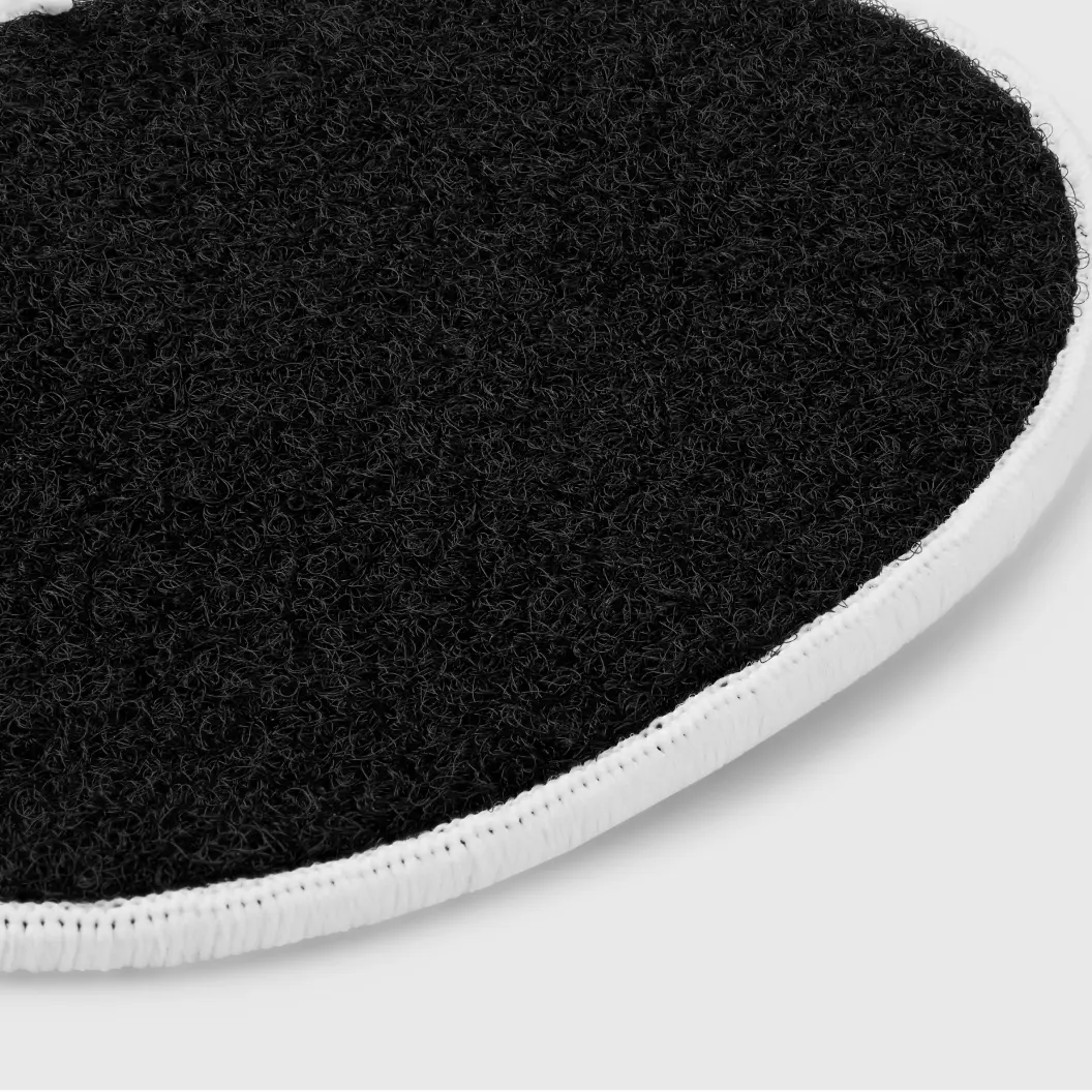 Close-up of Velcro backing on a black circular patch.