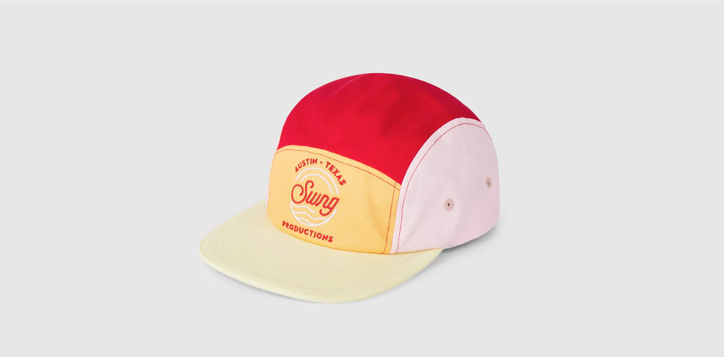 Multi-colored five-panel cap with red, yellow, and pink sections.