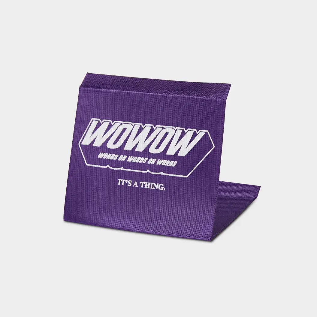 Purple printed label with bold white text “WOWOW: Words On Words On Words” and a subtext “IT’S A THING