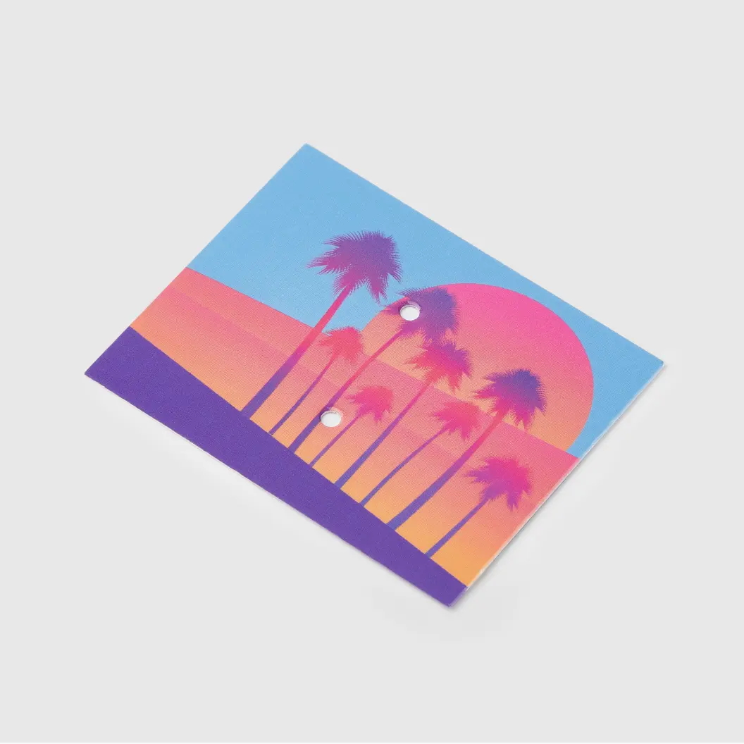 Colorful backer card with palm trees against a pink and purple sunset background.