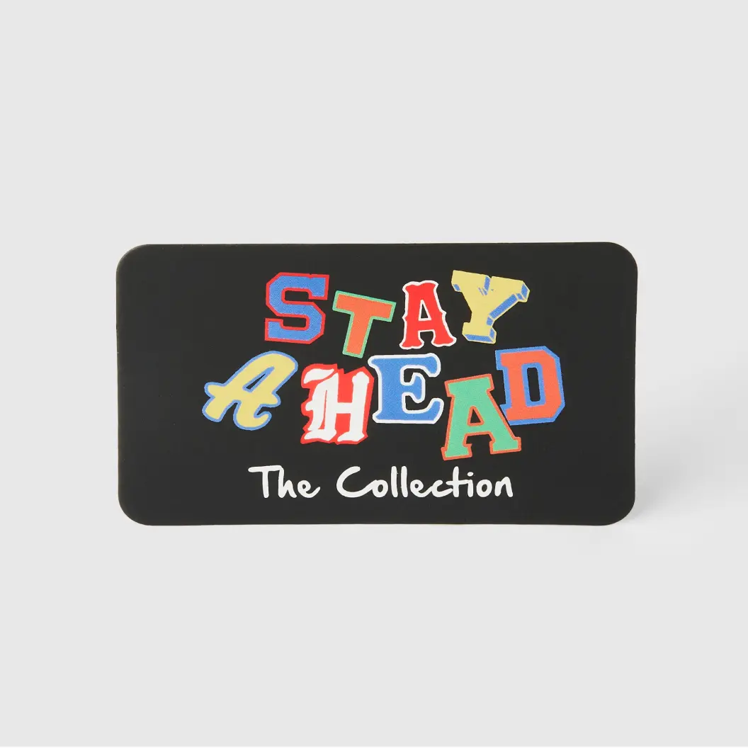 Black rectangular tag with colorful text that reads “Stay Ahead - The Collection,” in a playful, multicolored font.