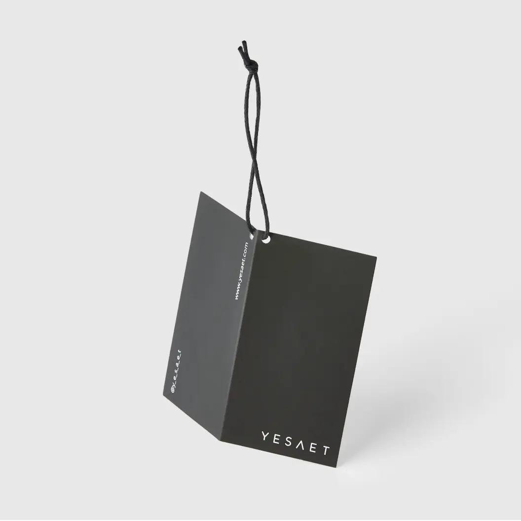 Black, folded hang tag with “YESAET” branding and a sleek black string, showcasing a minimalist design.