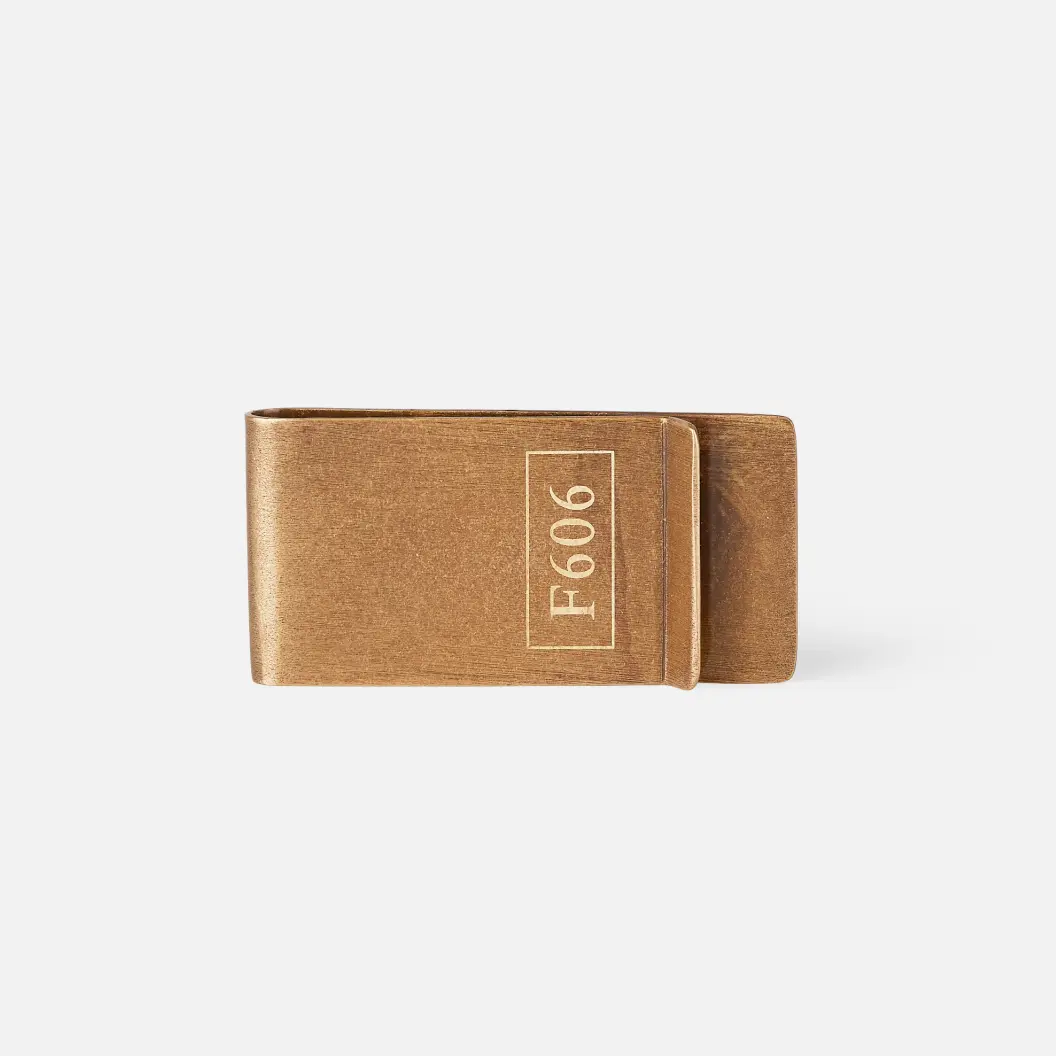 Matte gold rectangular money clip featuring the text “F606”.