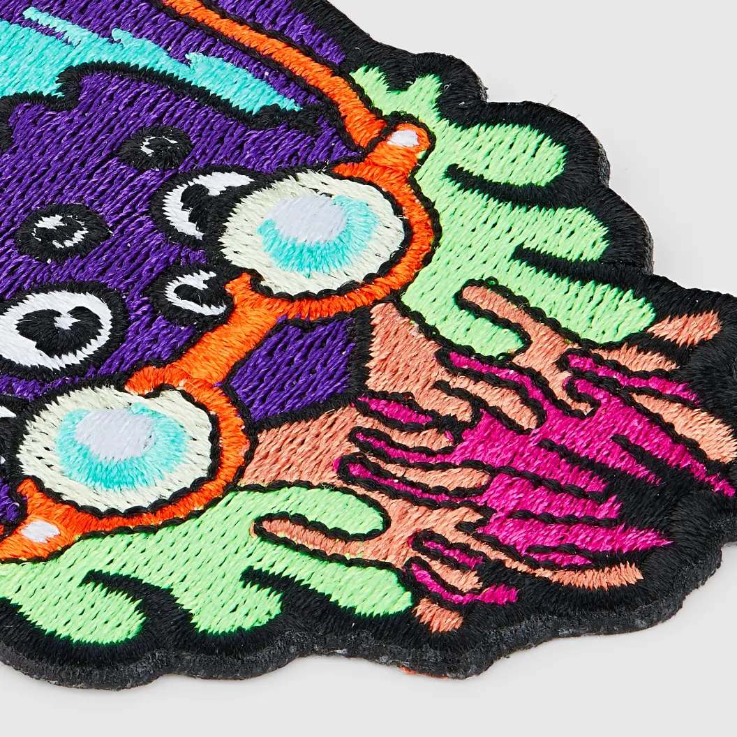 Close-up of vibrant patch with colorful stitches.