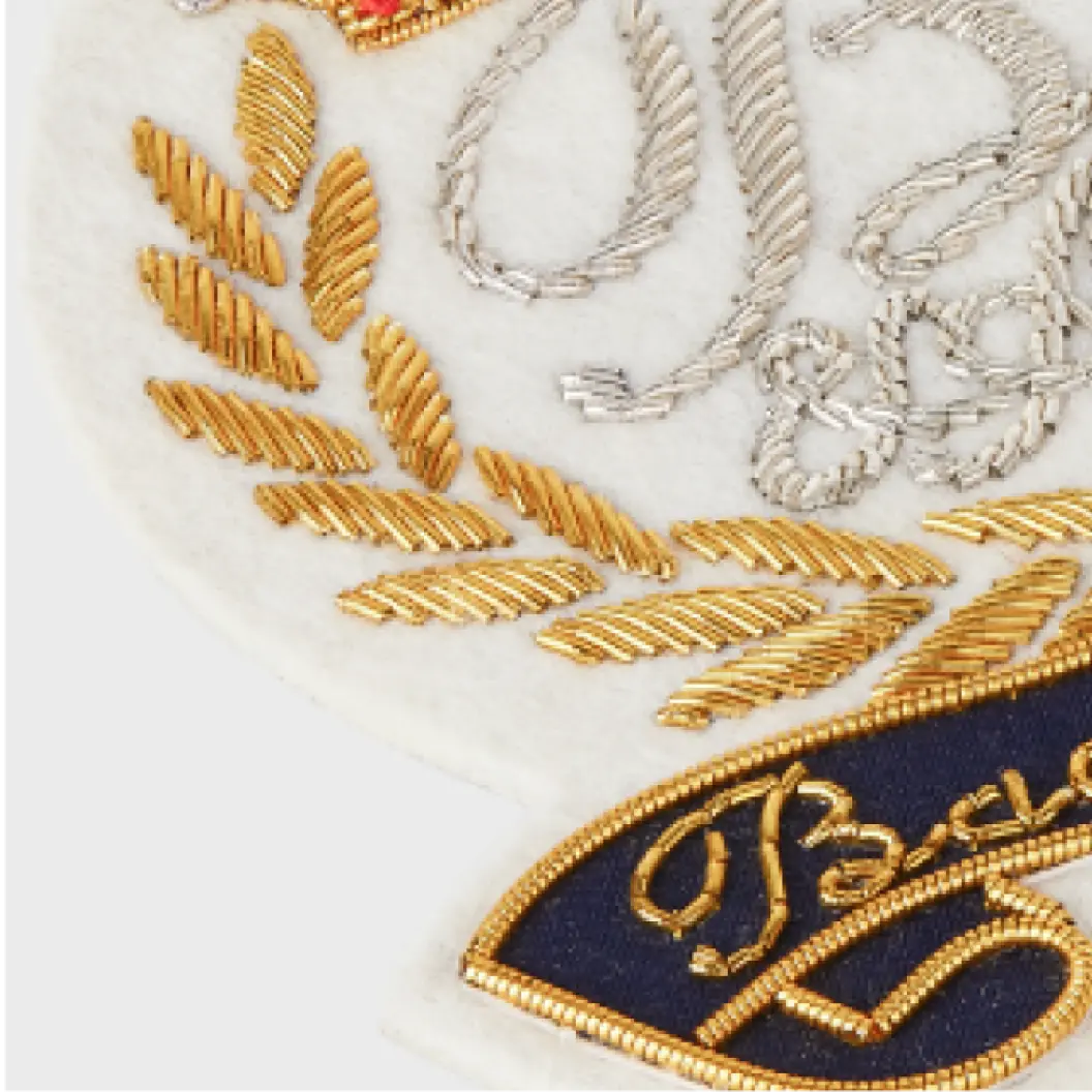 Close-up of a custom bullion patch, highlighting intricate stitching and metallic thread details.