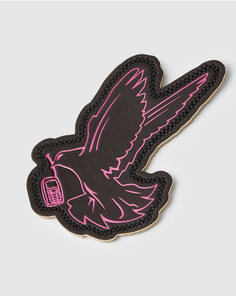 Custom black leather patch featuring vibrant pink outline of a bird holding a phone in its beak.