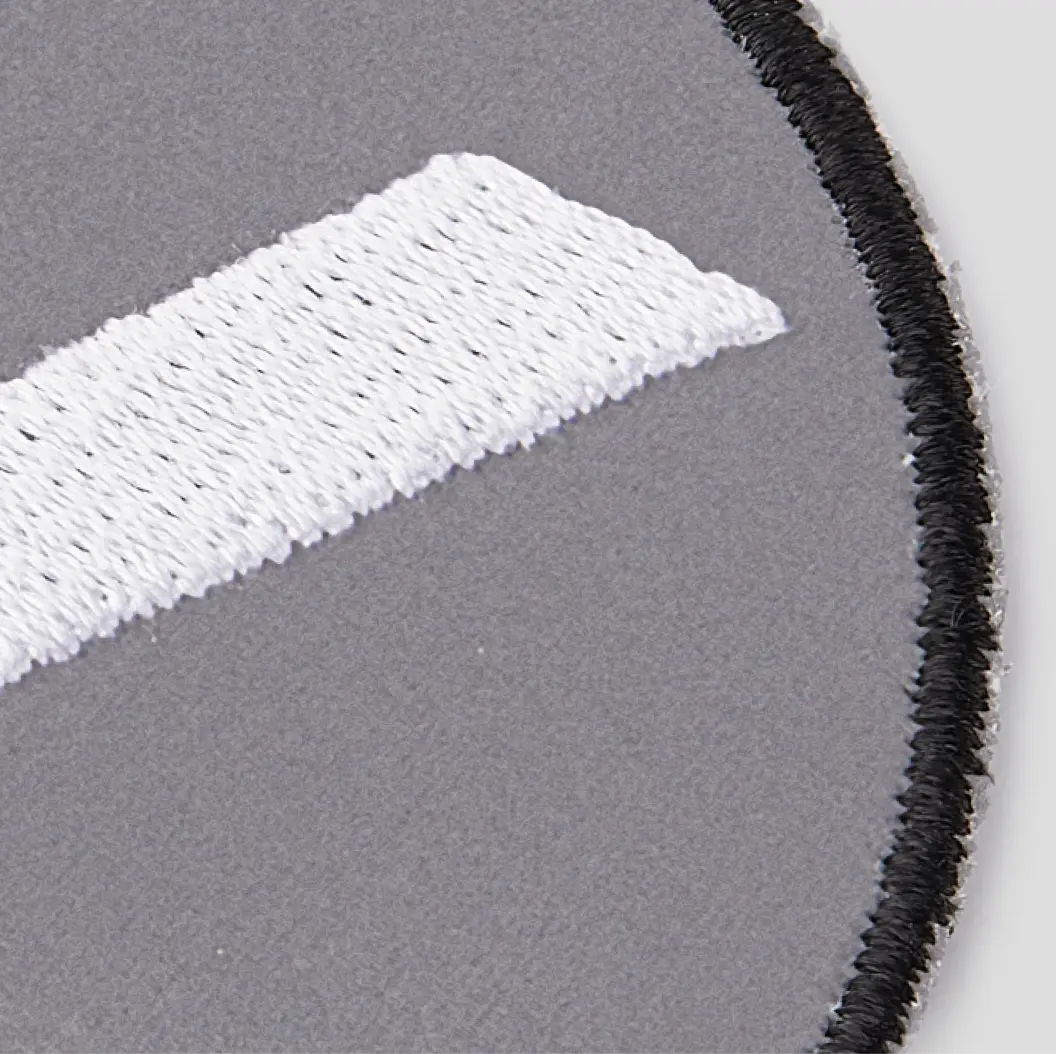 Close-up of embroidered border patch with reflective base material