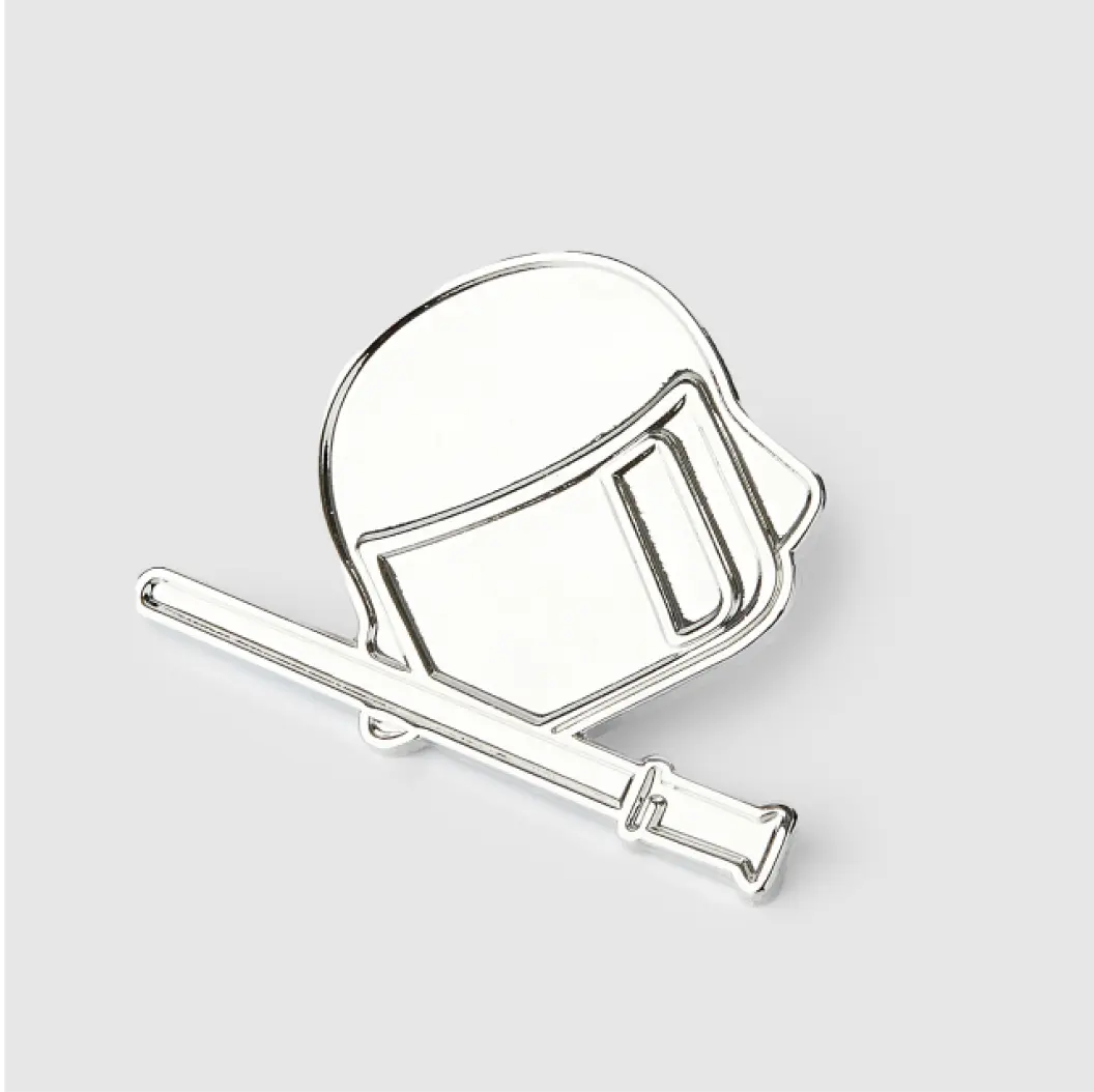 Silver die-struck pin featuring a helmet and baton design with intricate metallic details.