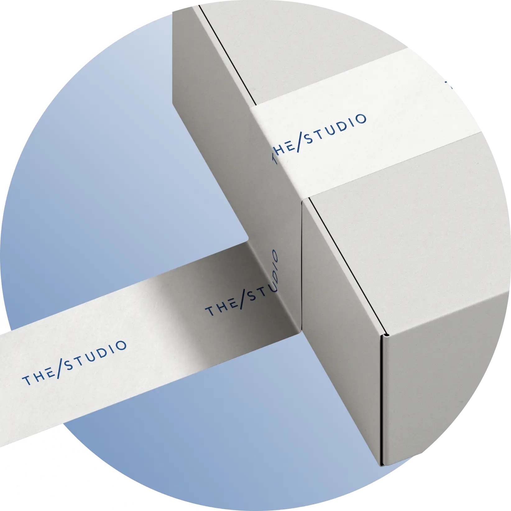 THE/STUDIO branded packaging tape sealing white shipping boxes