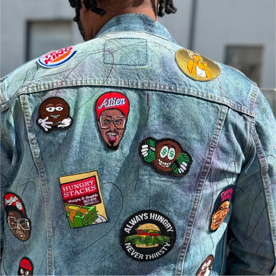 Denim jacket covered in vibrant custom patches, worn by a man