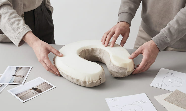 Neck pillow showing internal foam structure and removable fabric cover construction