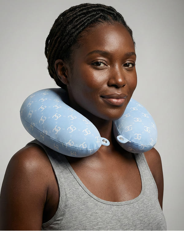 Contoured neck pillow with ergonomic support and soft fabric surface construction