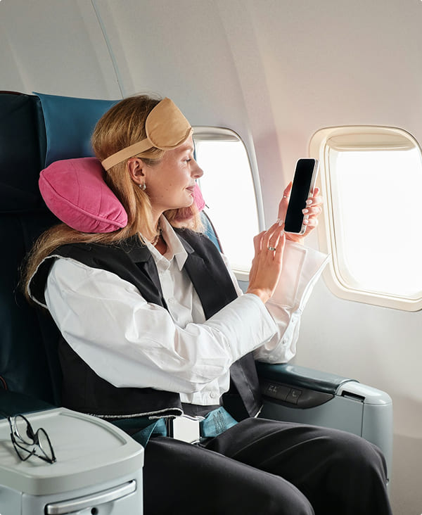 Contoured travel neck pillow supporting head position during seated transportation use