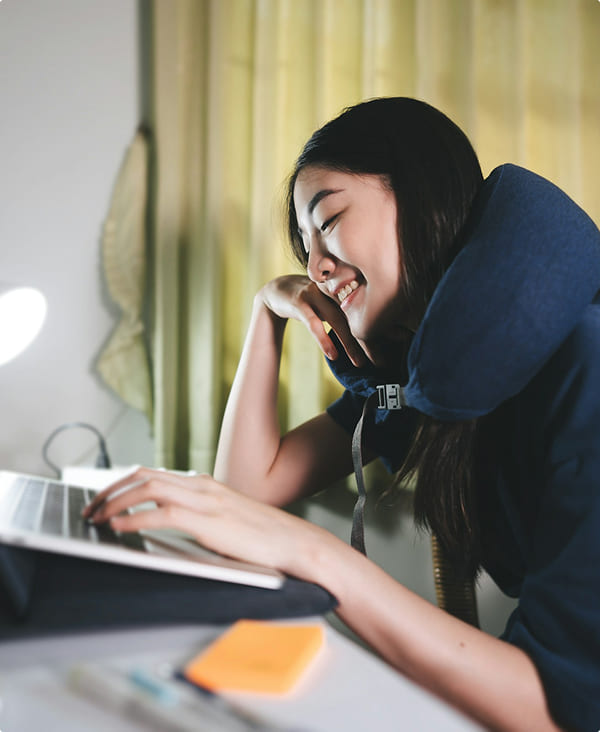 Travel neck pillow in use showing ergonomic support during seated rest