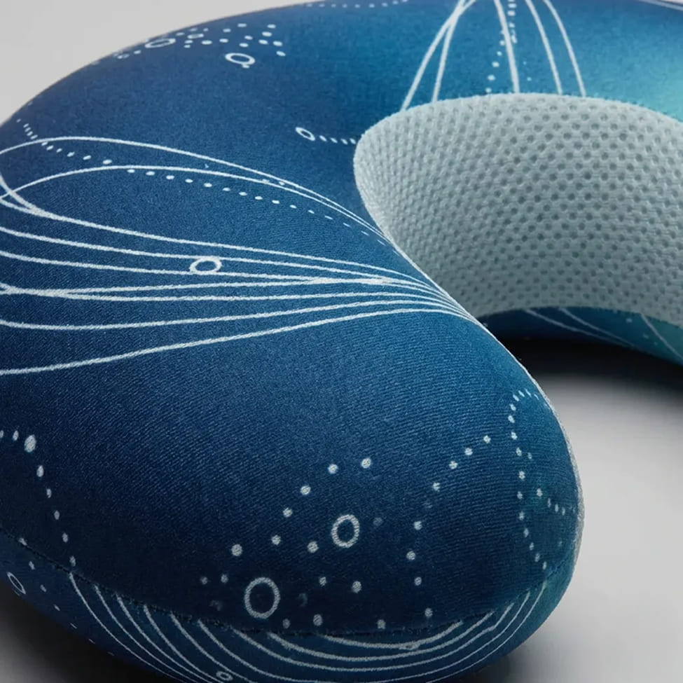 Contoured travel neck pillow with breathable fabric panels and structured foam support